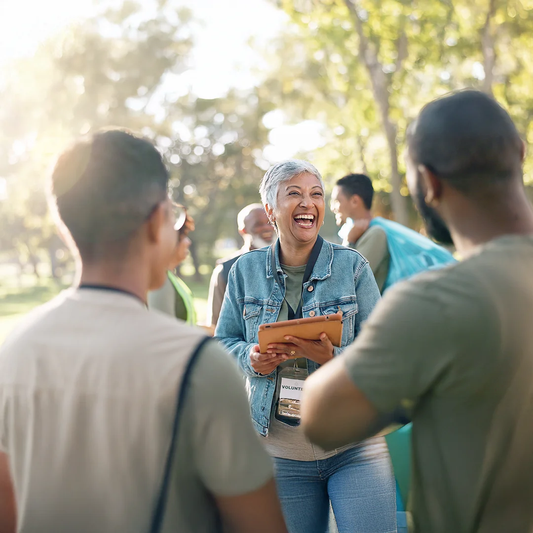 Community members laughing and connecting outdoors during a collaborative gathering